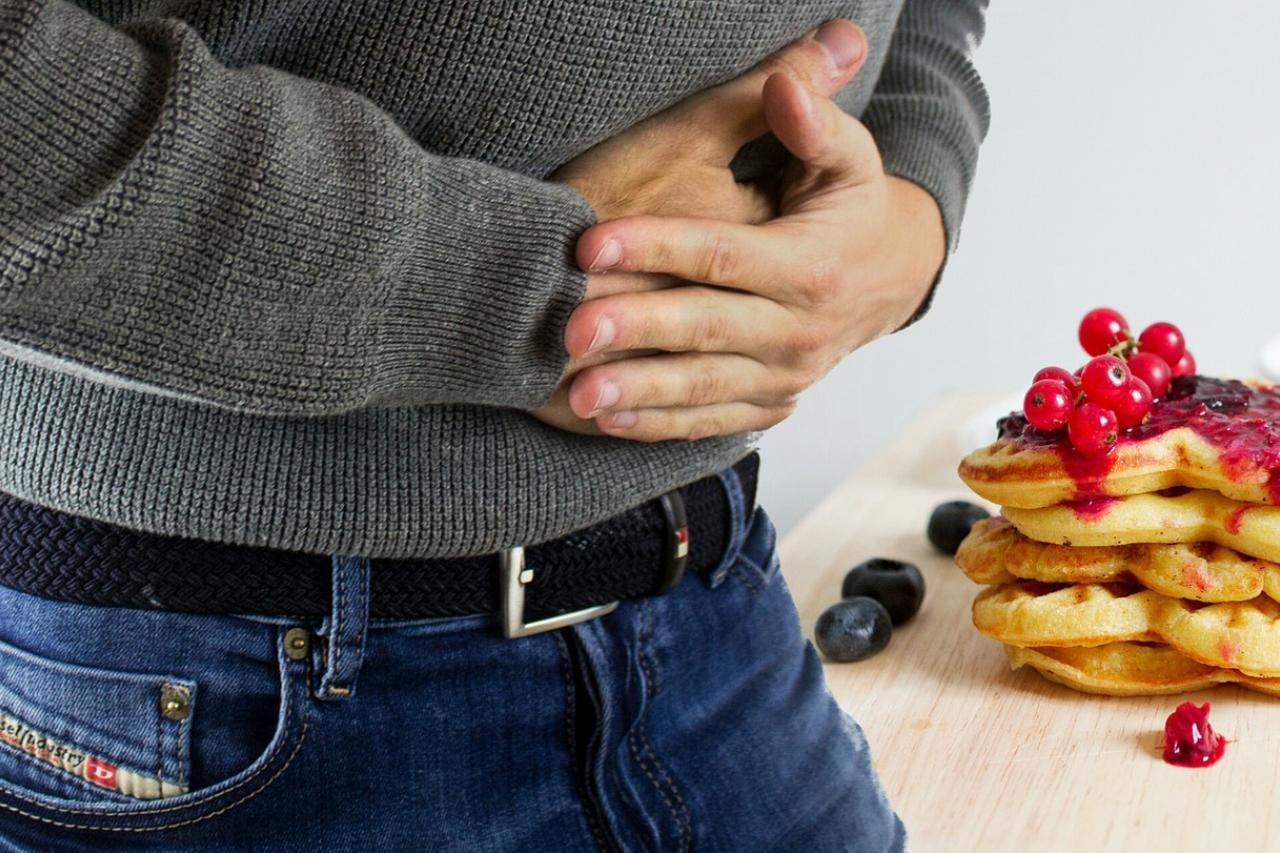 Man holding stomach