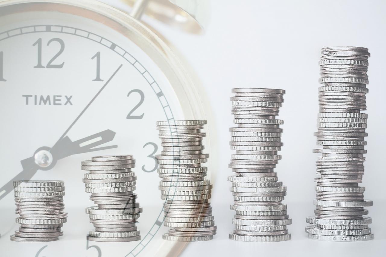 a stack of coins with an image of a clock in the background