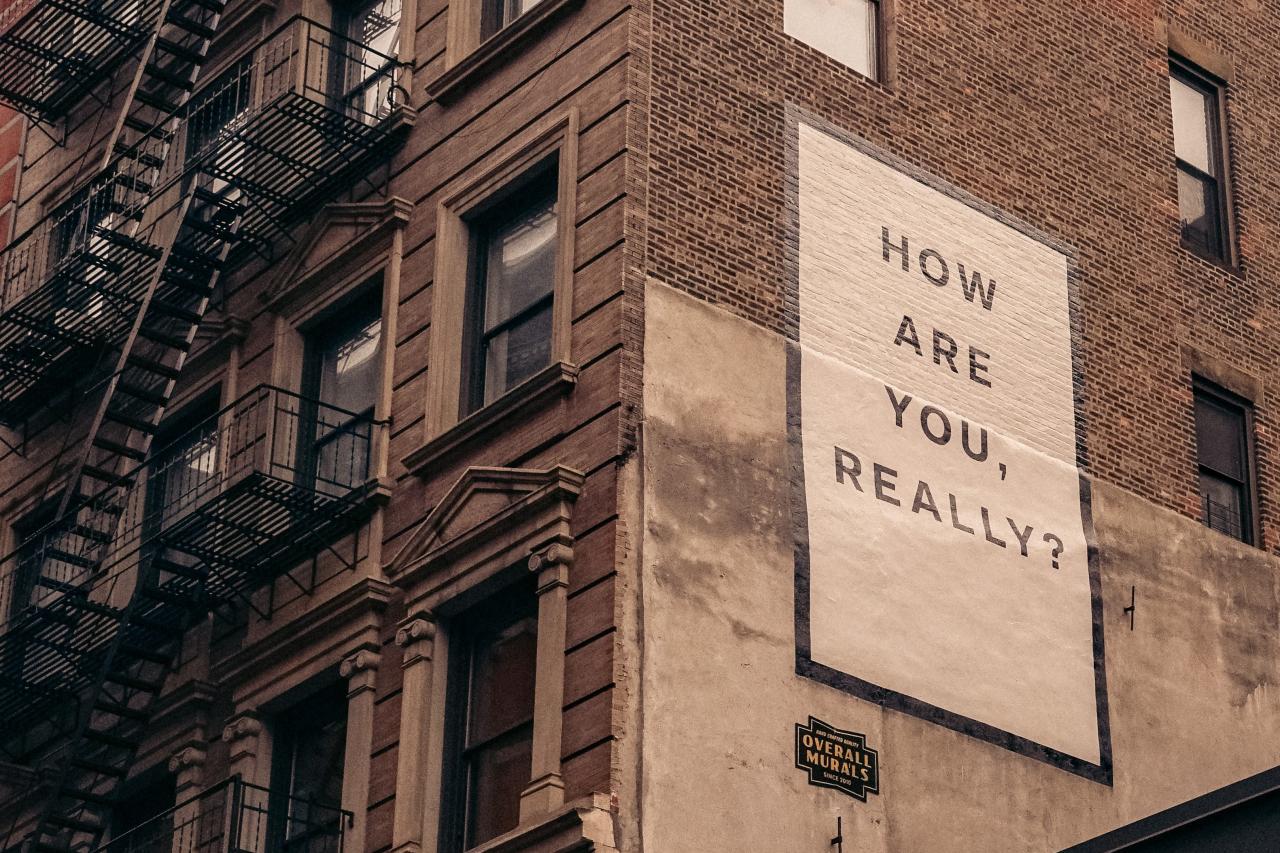 a large sign on the side of a brick building that says, "How are you, really?"