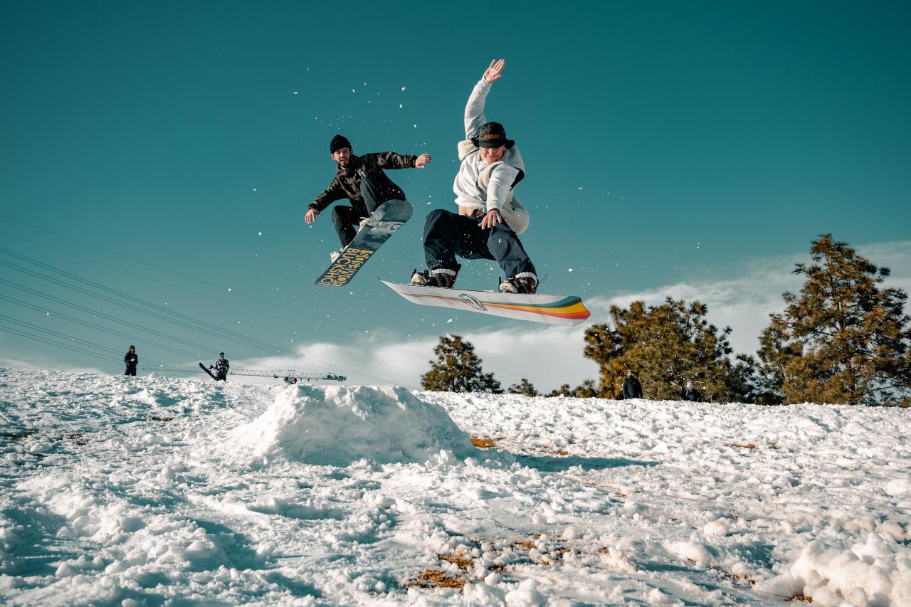 Photo by <a href="https://unsplash.com/@onthesearchforpineapples?utm_source=unsplash&utm_medium=referral&utm_content=creditCopyText">Colin Lloyd</a> on <a href="https://unsplash.com/s/photos/winter-sports?utm_source=unsplash&utm_medium=referral&utm_content=creditCopyText">Unsplash</a> snowboarders flying through the air off a self-made ramp