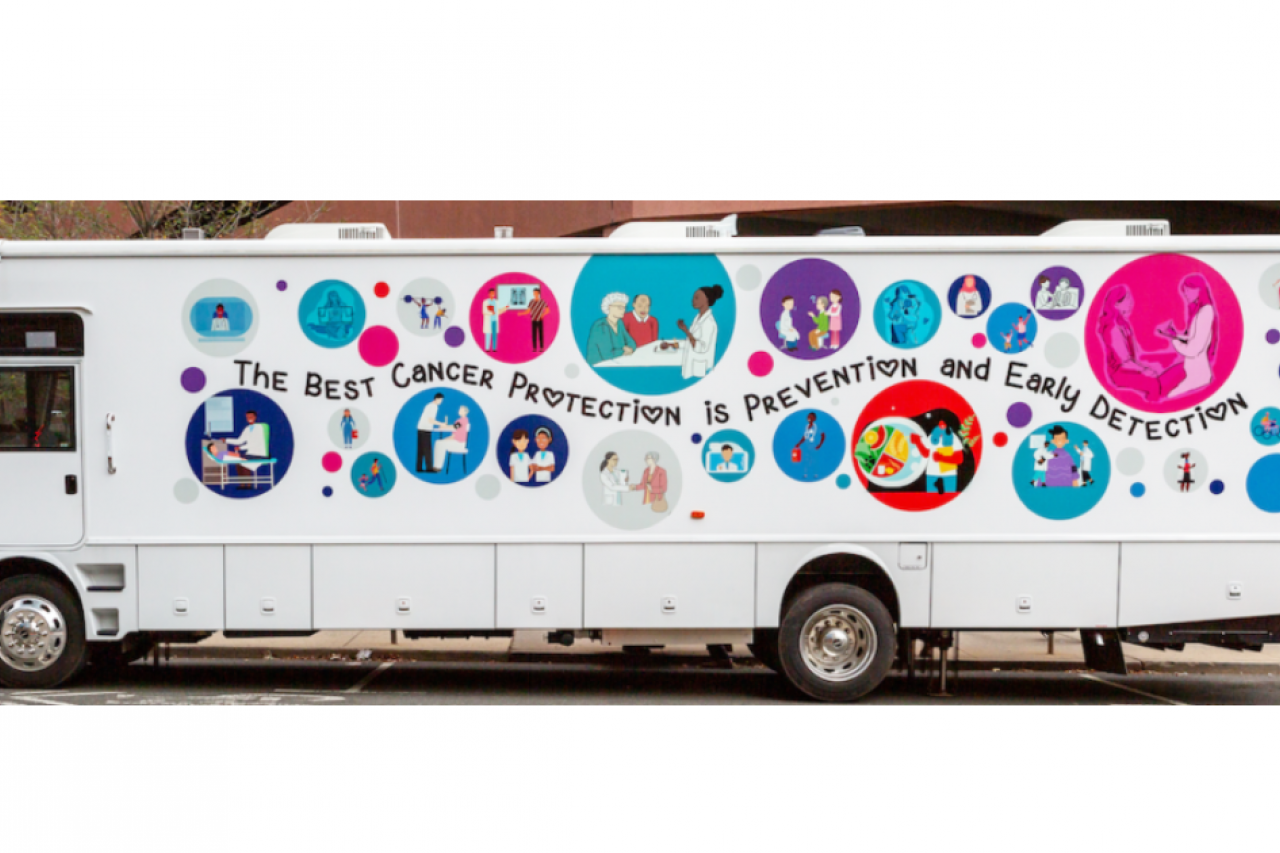 Picture of Screen NJ's "LifeSaver" Mobile Health Unit bus' side-long banner which reads, 'The best cancer protection is prevention and early detection'.