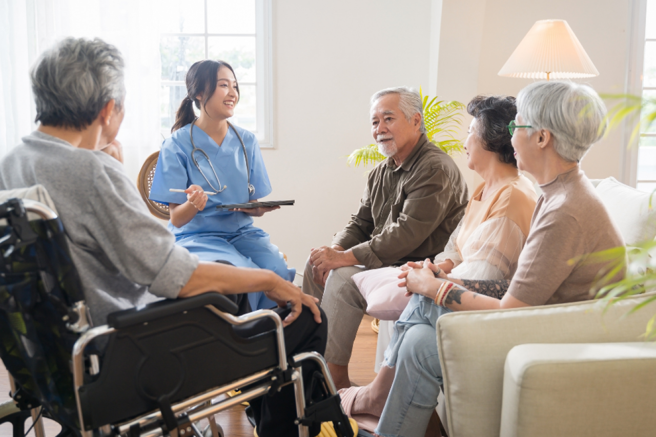 Patients talking with a healthcare worker holding a clipboard