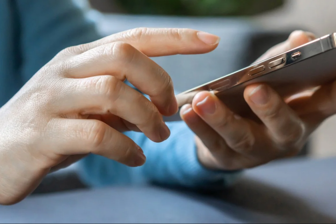 Person about to type on iPhone.