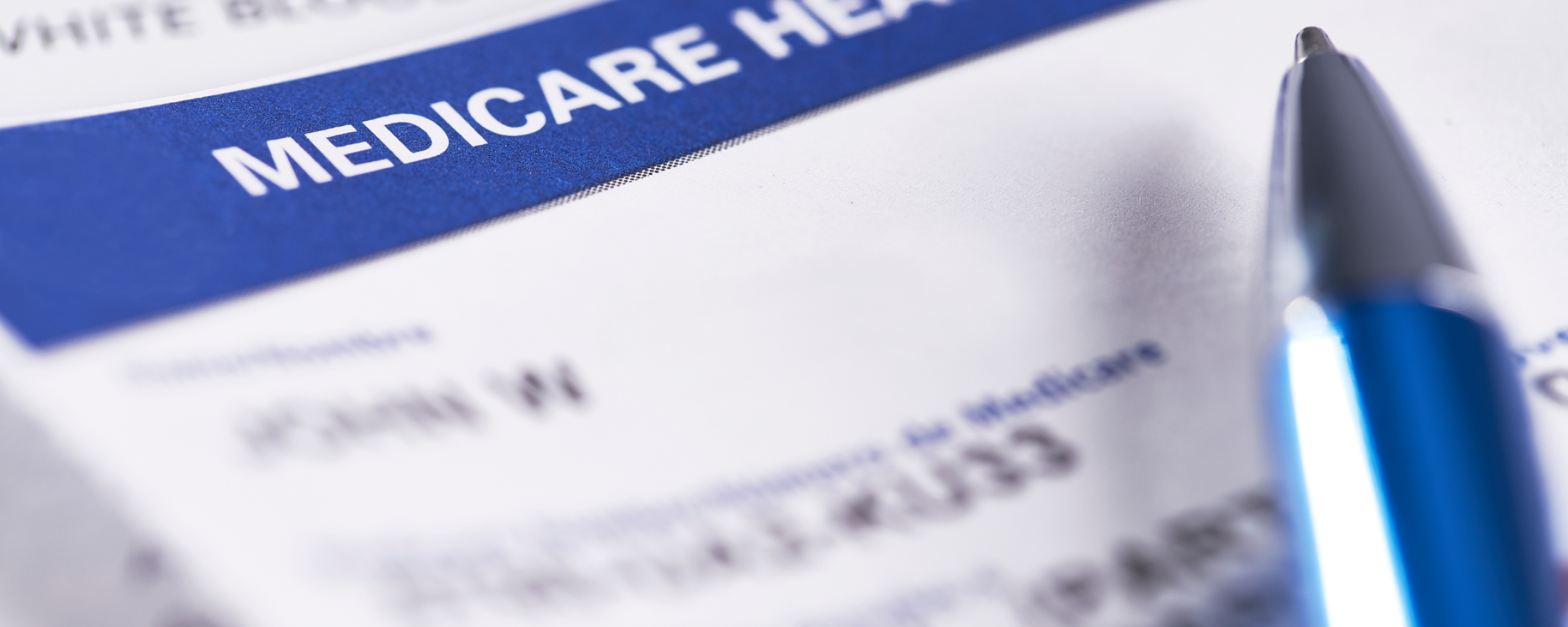 Close up of Medicare insurance card with pen