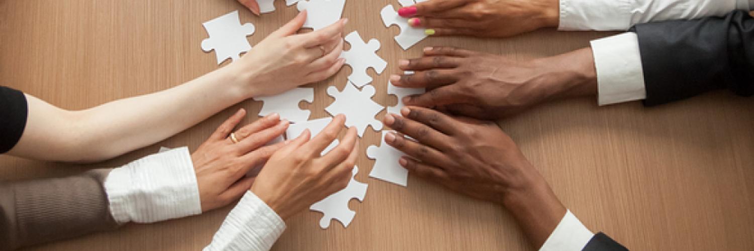 2020 Census people's hands solving a puzzle