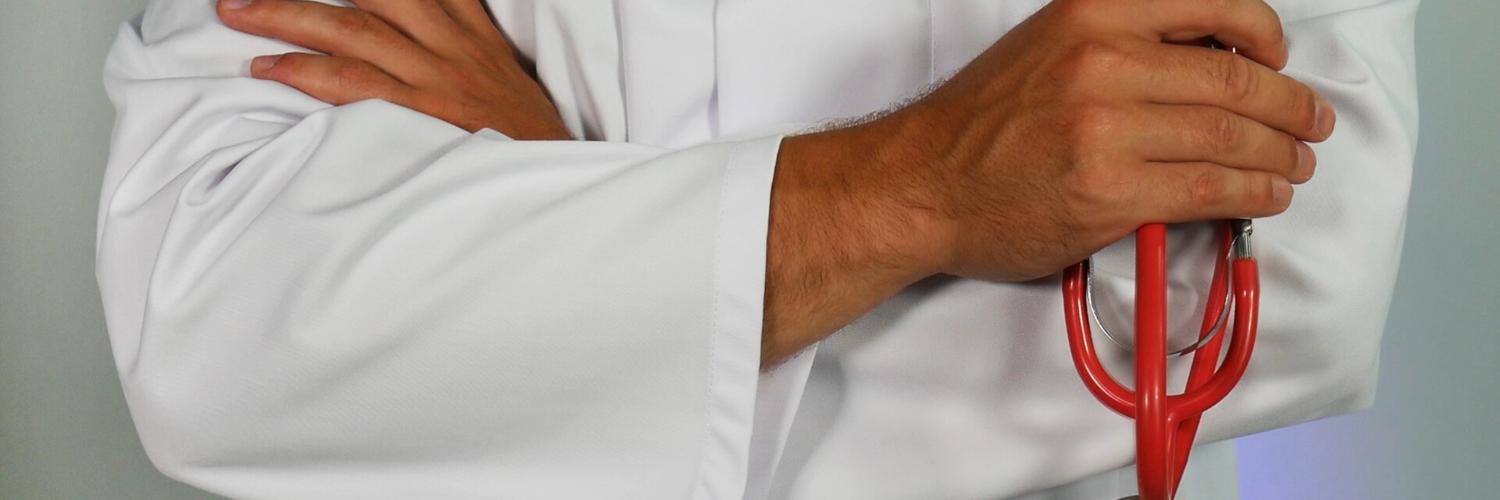 doctor holding red stethoscope