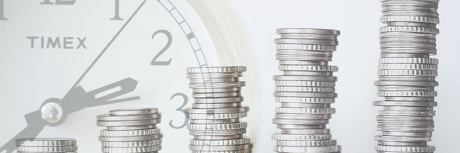 a stack of coins with an image of a clock in the background