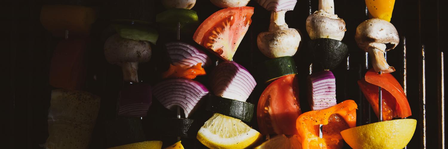 skewered vegetables on a grill