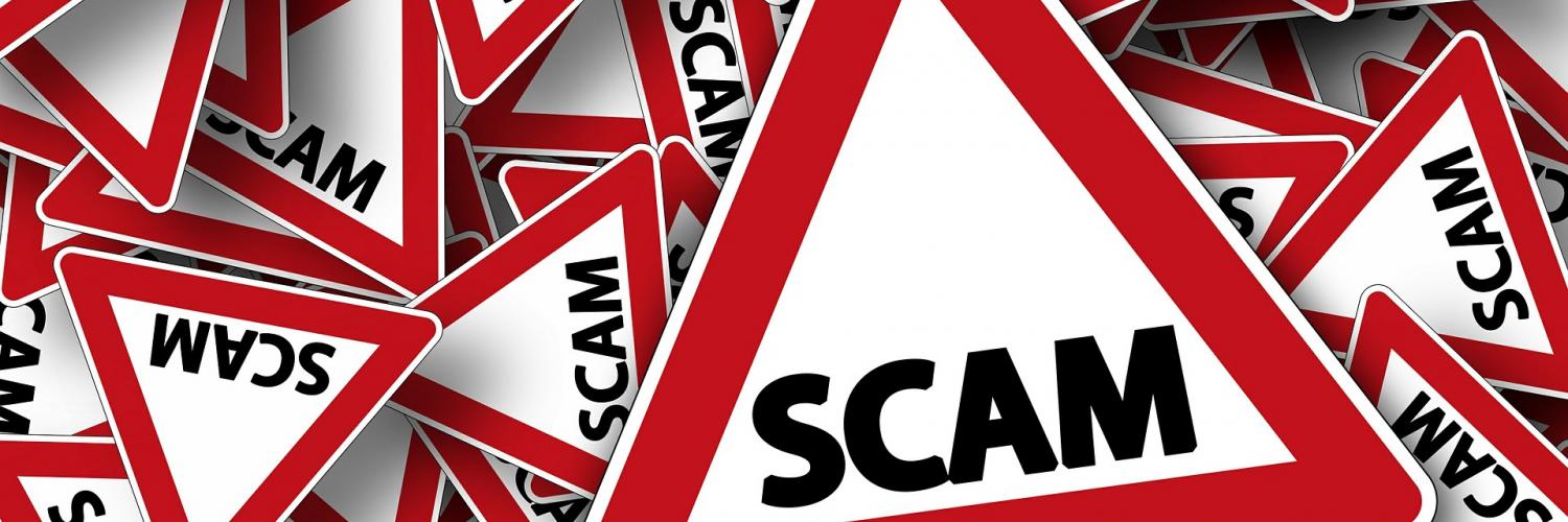 a stack of signs that say "scam" on them