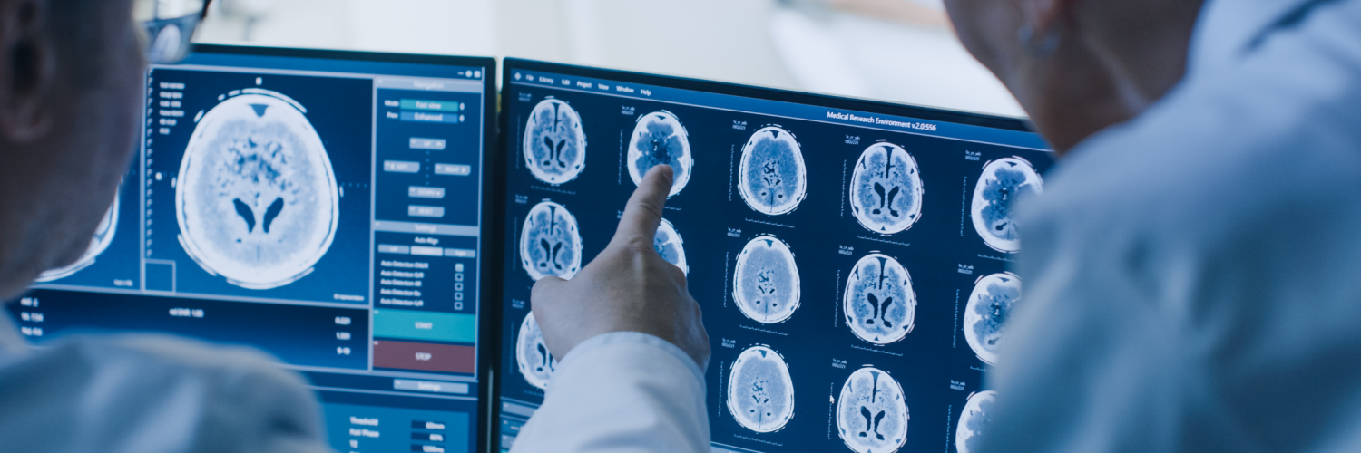 Doctor and radiologist discuss diagnosis while watching procedure and monitors showing patient's brain scan results