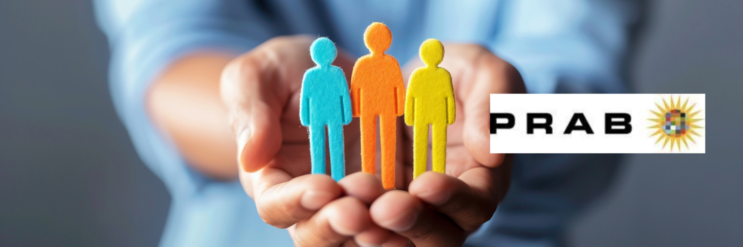 Hands stretched out holding paper cut-out of a family with the PRAB logo above